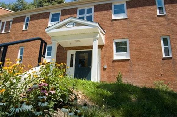 a red brick building with a door and a porch