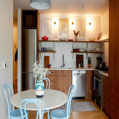 a kitchen and dining area with a table and chairs