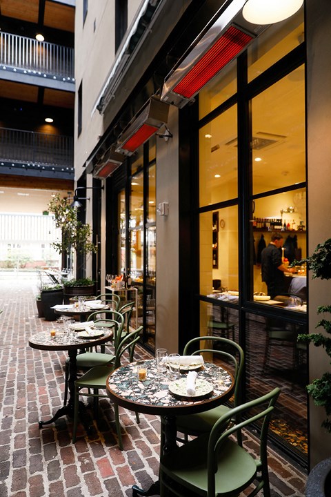 a row of tables at a restaurant with chairs