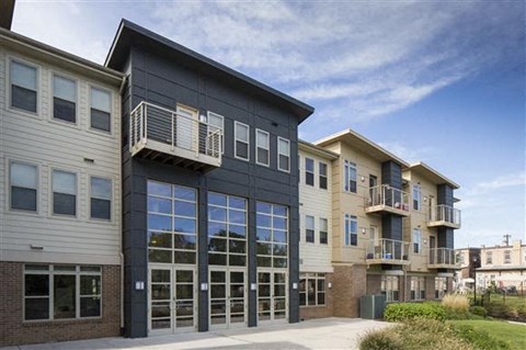 a building with two balconies and a sidewalk