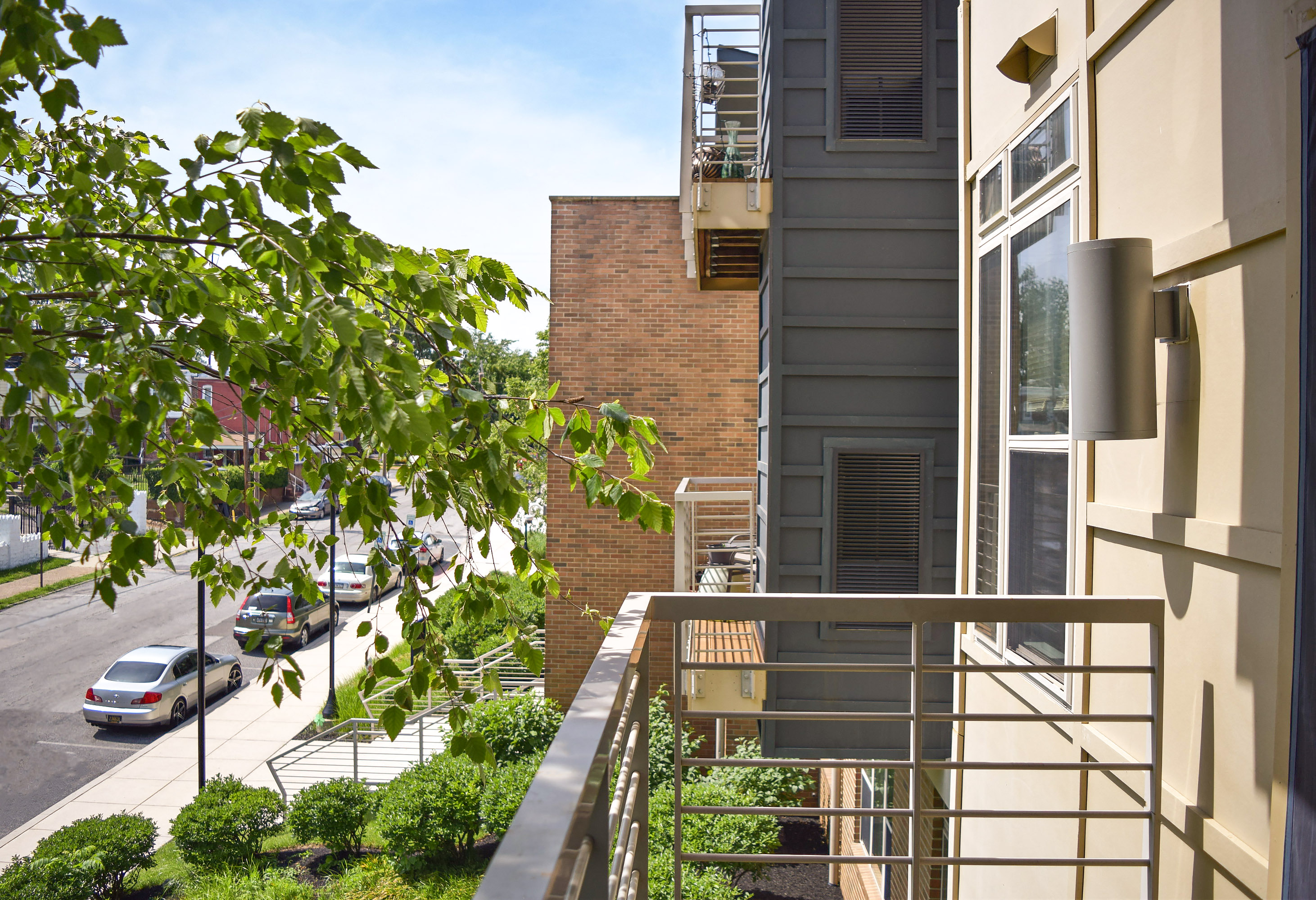 a view of the street from a balcony of an apartment building