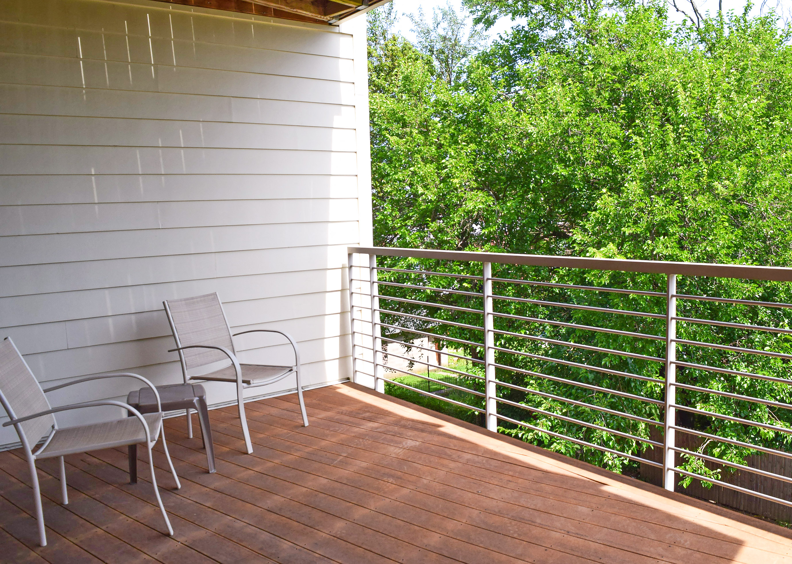 a balcony with a table and chairs on it