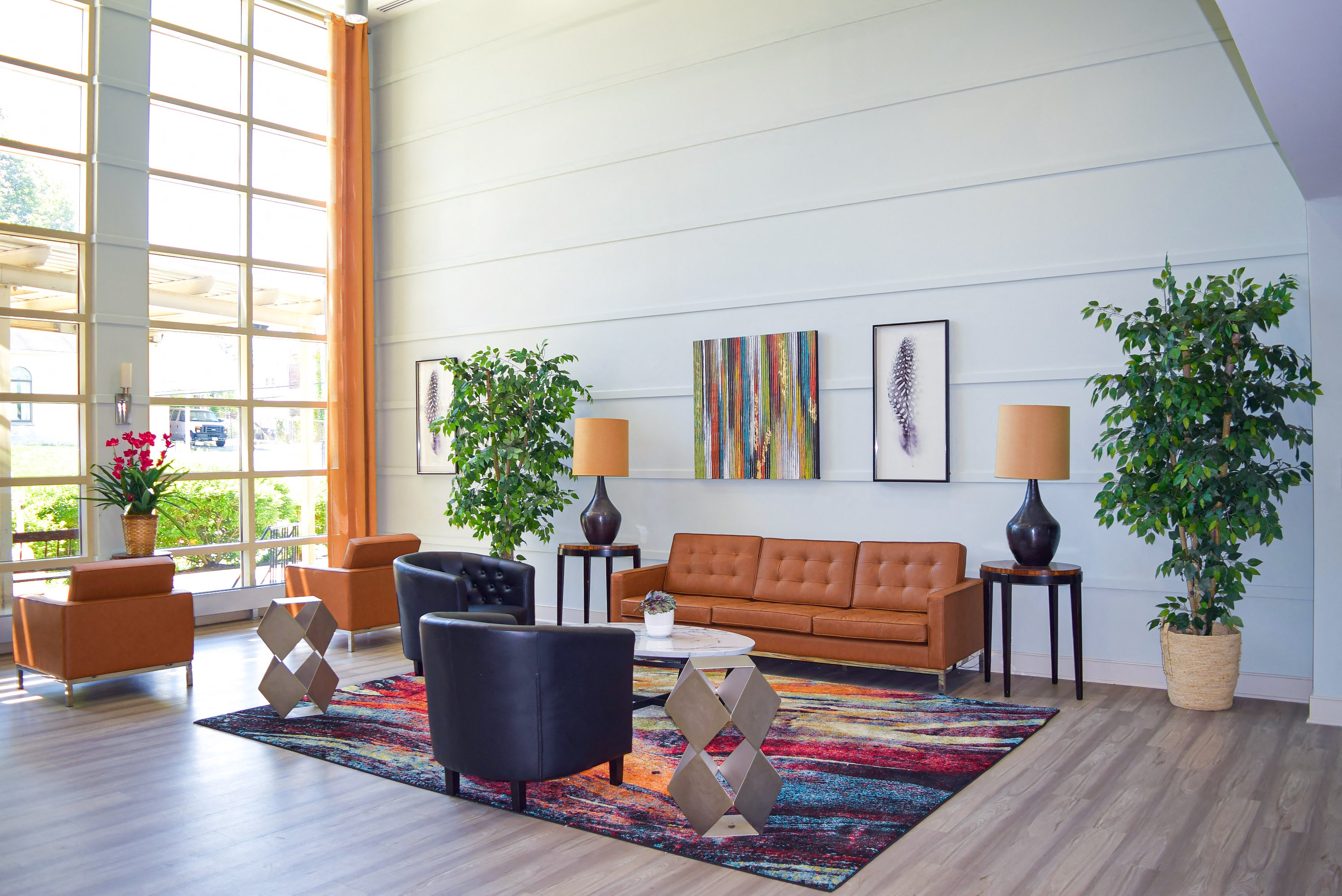 a living room with couches and chairs and a rug