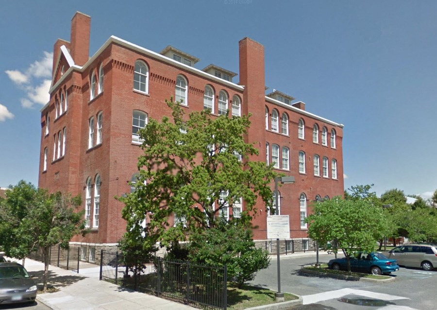 a large brick building on the corner of a street