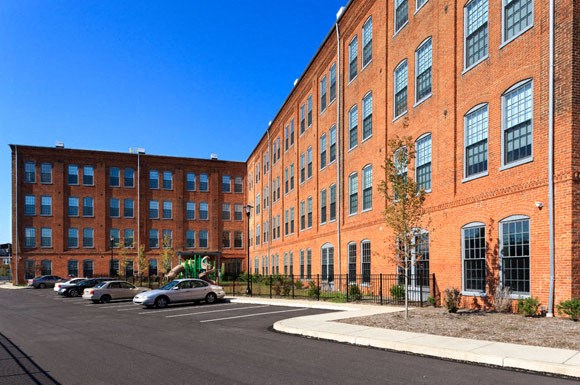 a large brick building with cars parked in front of it