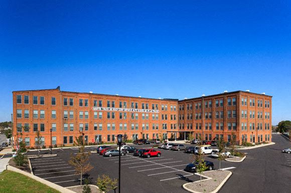 a large brick building with a parking lot