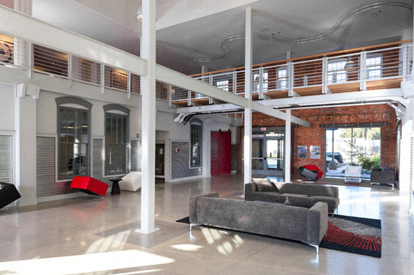 a large living room with a couch and a balcony