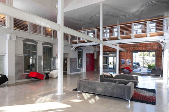 a large living room with a couch and a balcony