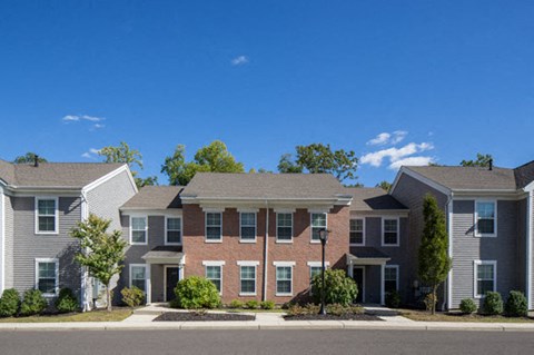 an apartment building with a street in front of it