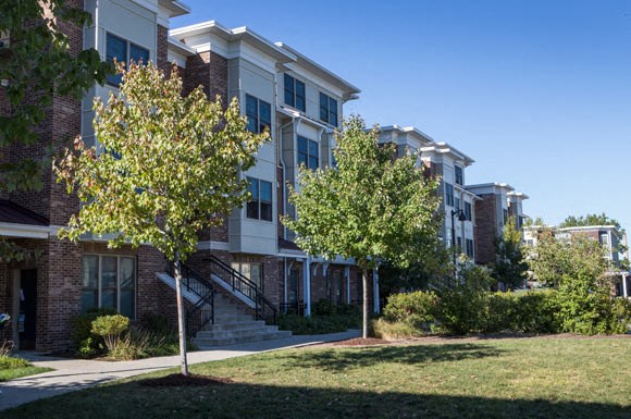 an apartment building with trees in front of it