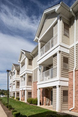 a row of houses with balconies on a street