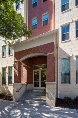 the front of a brick building with a door