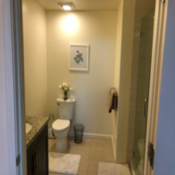 a bathroom with a toilet and a sink and a shower