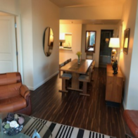 a living room and dining room with a couch and a table