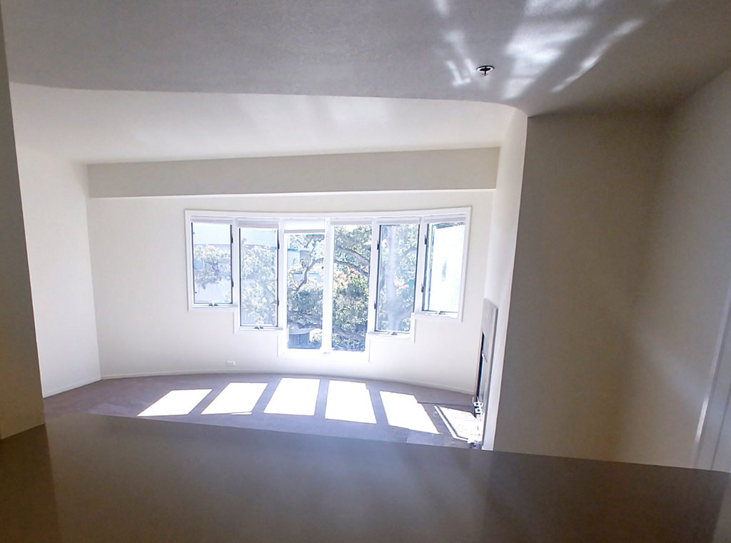 an empty living room with a large window