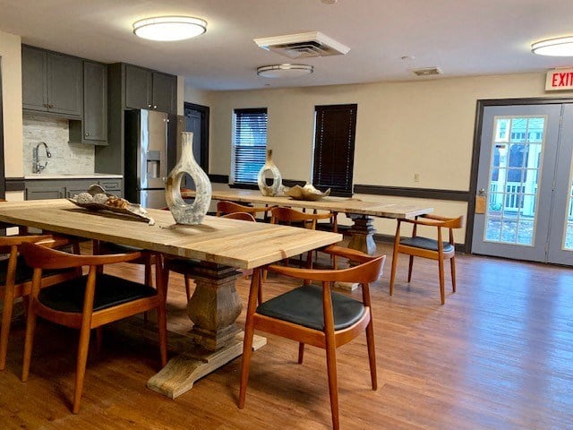 a large dining room with wooden tables and chairs
