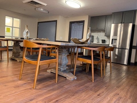 a kitchen with a wooden table and chairs