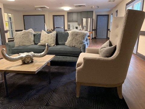 a living room with couches and chairs and a table