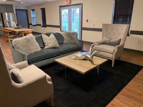 a living room with couches and chairs and a table