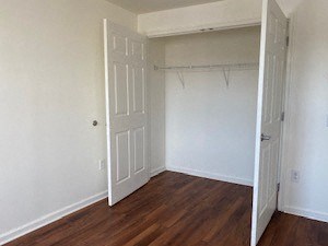 an empty bedroom with white walls and a door