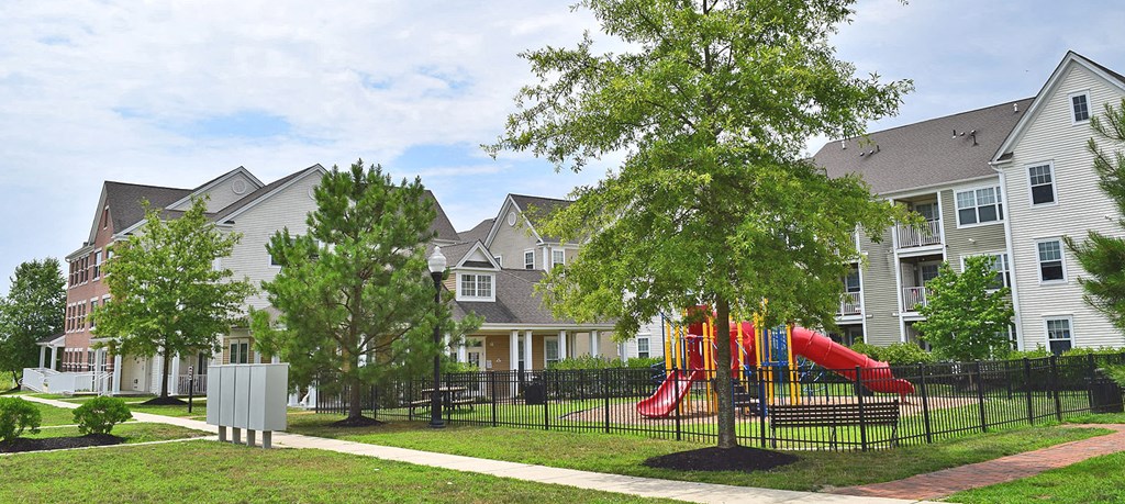 a playground in front of a row of houses