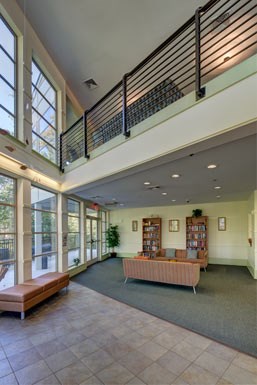 the lobby of a building with a couch and benches
