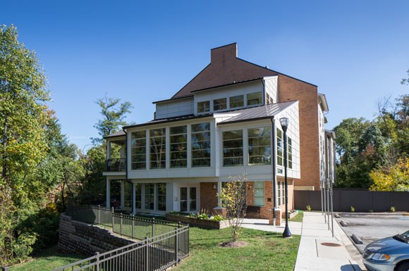 a large house with a sidewalk in front of it