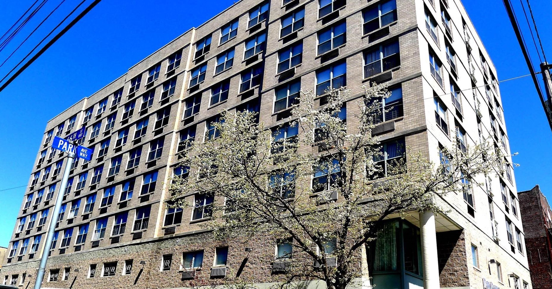a tall building with a tree in front of it