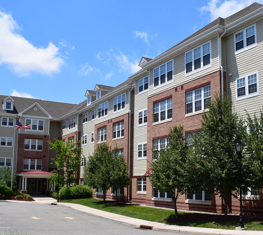 an apartment building with a street in front of it