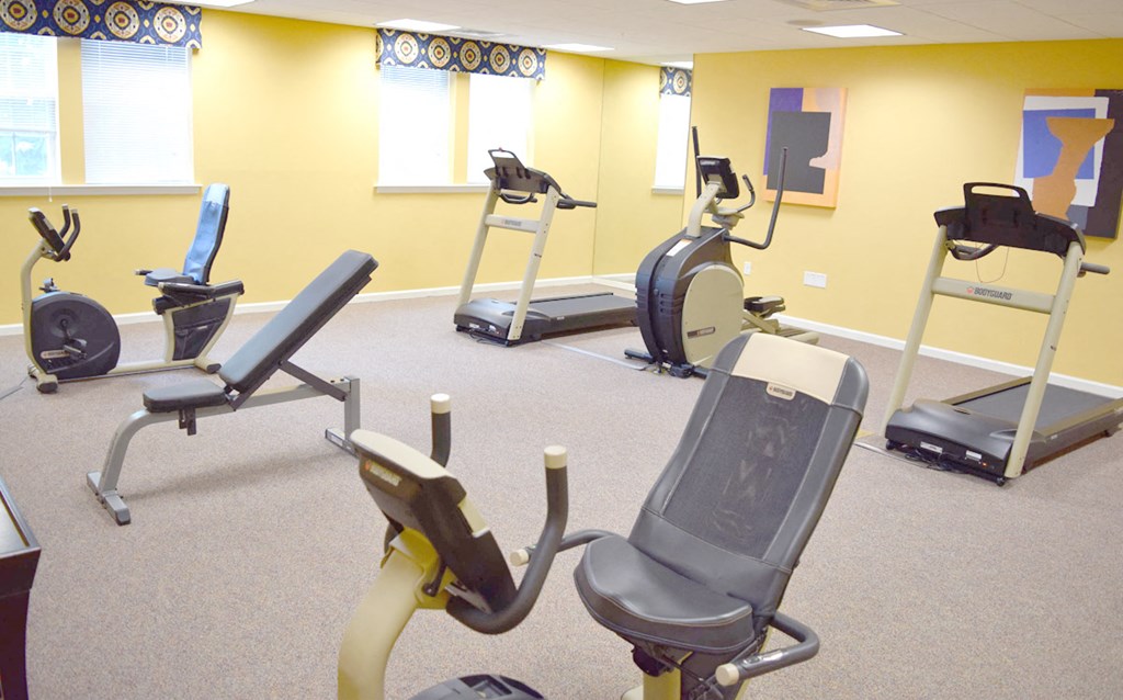 a gym with various exercise equipment in a treatment room