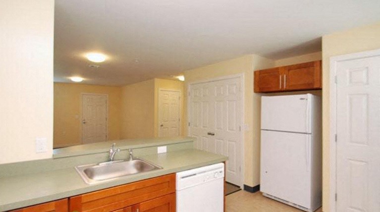 a kitchen with a sink and a refrigerator