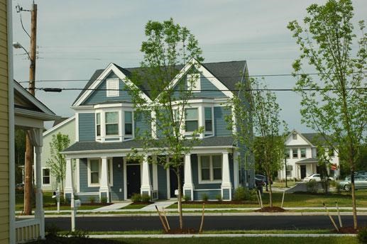 a blue house on the side of a street