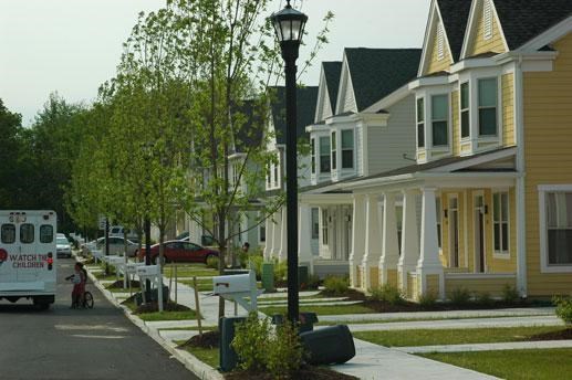 a row of houses on a street with a truck