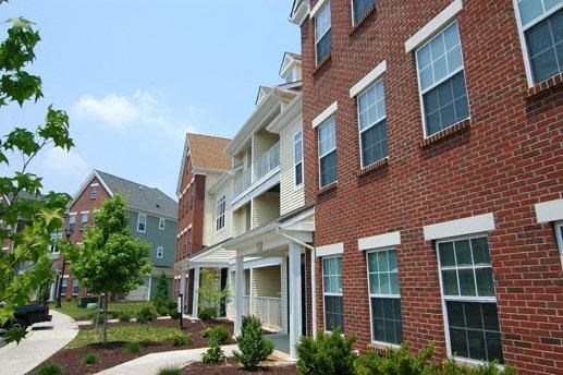 a brick building with a sidewalk in front of it