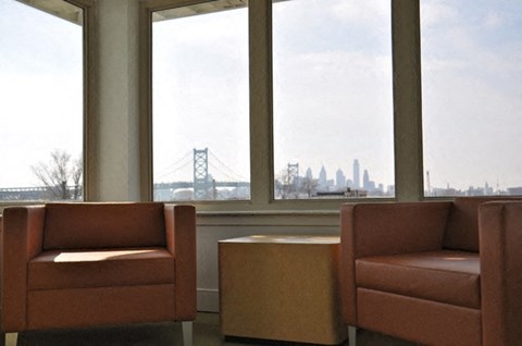 two chairs in front of a window with a city view