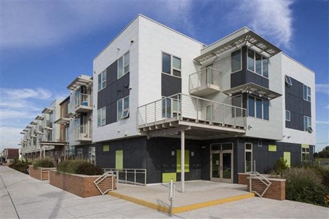 a row of apartment buildings with balconies and stairs