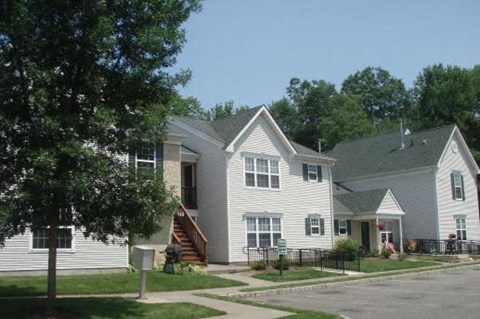 a group of white houses on the side of a street
