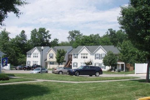 a group of cars parked in front of houses