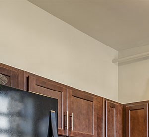 a kitchen with wooden cabinets and a black refrigerator