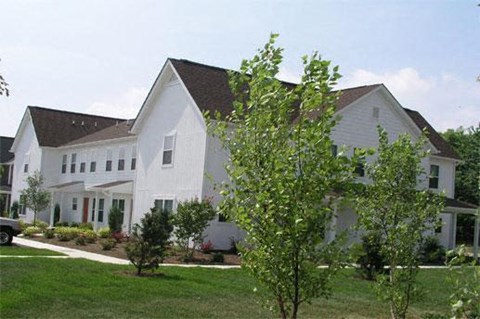 a large white house with trees in front of it