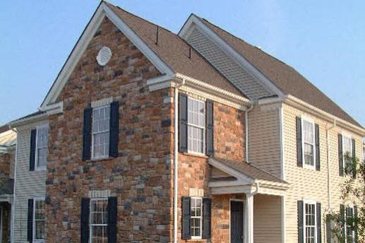 a large brick house with a brown roof