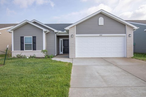 a house with a white garage door and a driveway