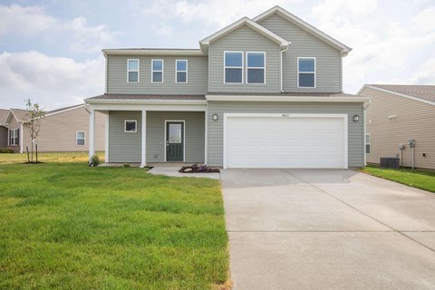 a house with a white garage door and a driveway