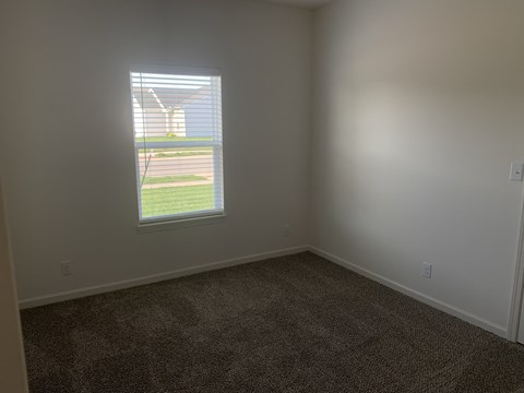 a room with a window and a carpet