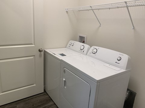 a washer and dryer in a laundry room with a door