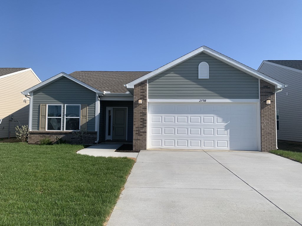 a gray house with a white garage door