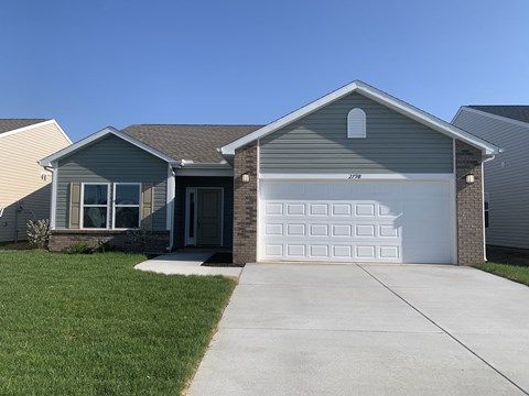 a gray house with a white garage door