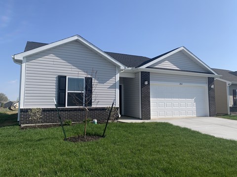 a house with a yard and a white garage door