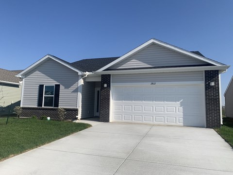 a house with a white garage door and a driveway