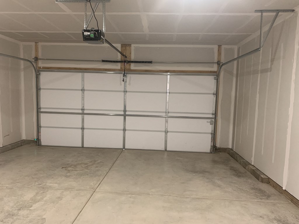a garage with a white door and white walls